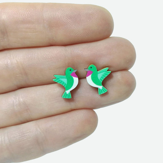 Wooden hummingbird stud earrings held on hand