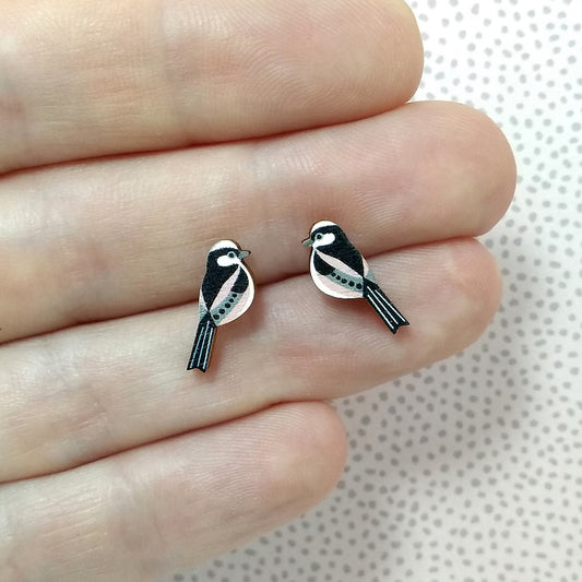 Wooden long tailed tit stud earrings held on hand
