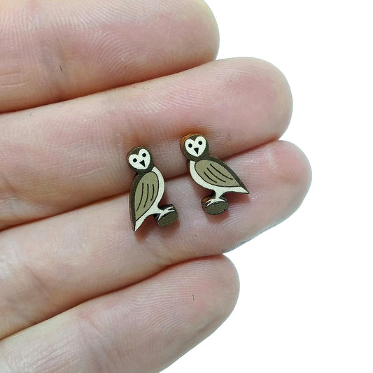Wooden owl stud earrings held on hand
