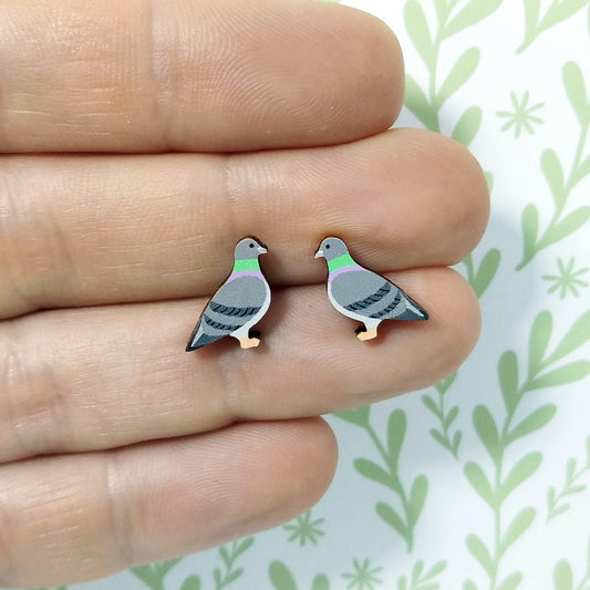 Wooden pigeon stud earrings held on hand