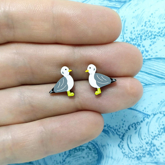 Wooden seagull stud earrings held on hand