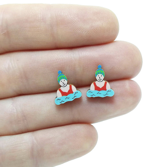 Wooden wild swimmer stud earrings held on hand