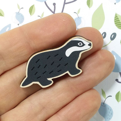 Wooden badger pin badge held on hand