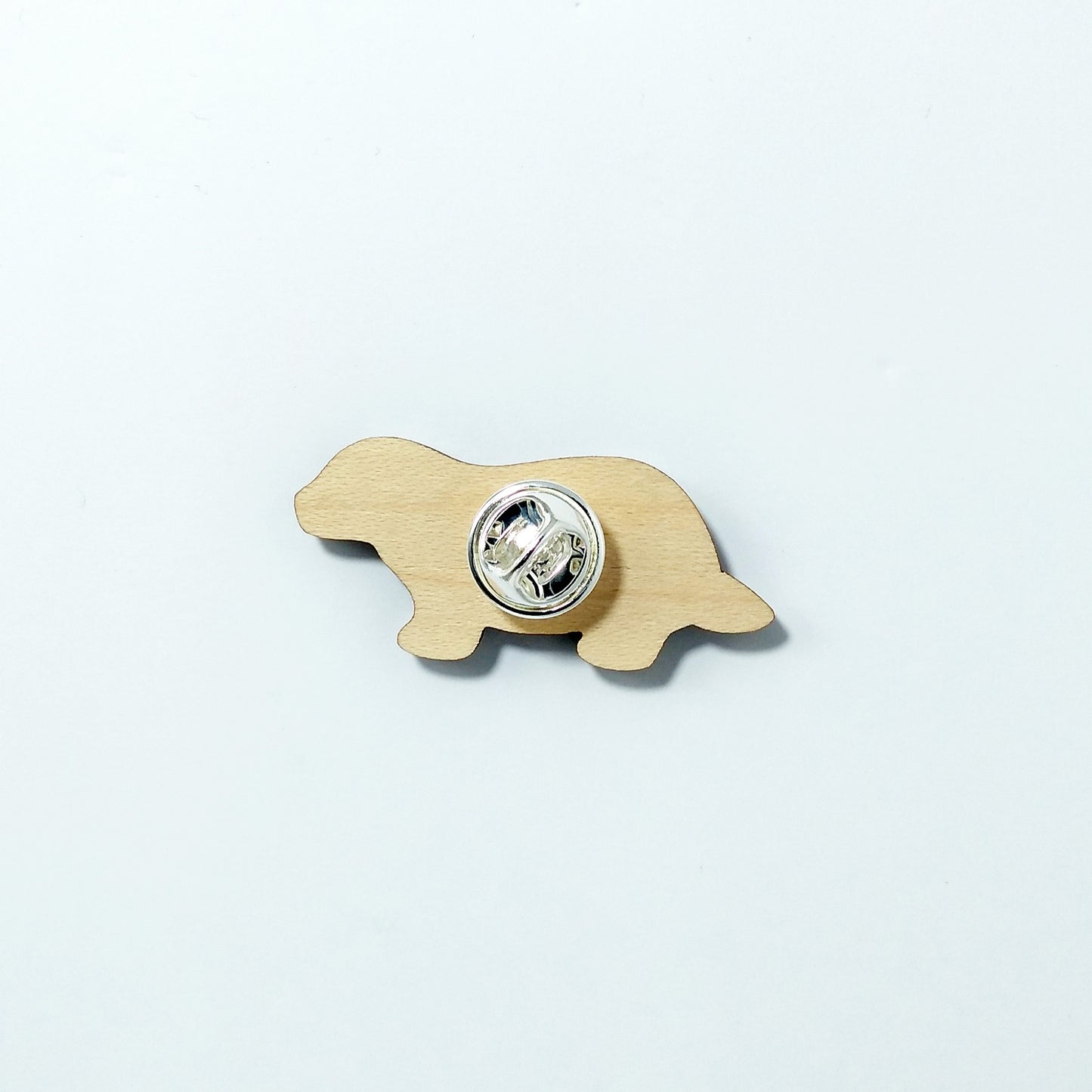 Back of badger pin badge showing metal butterfly clutch pin