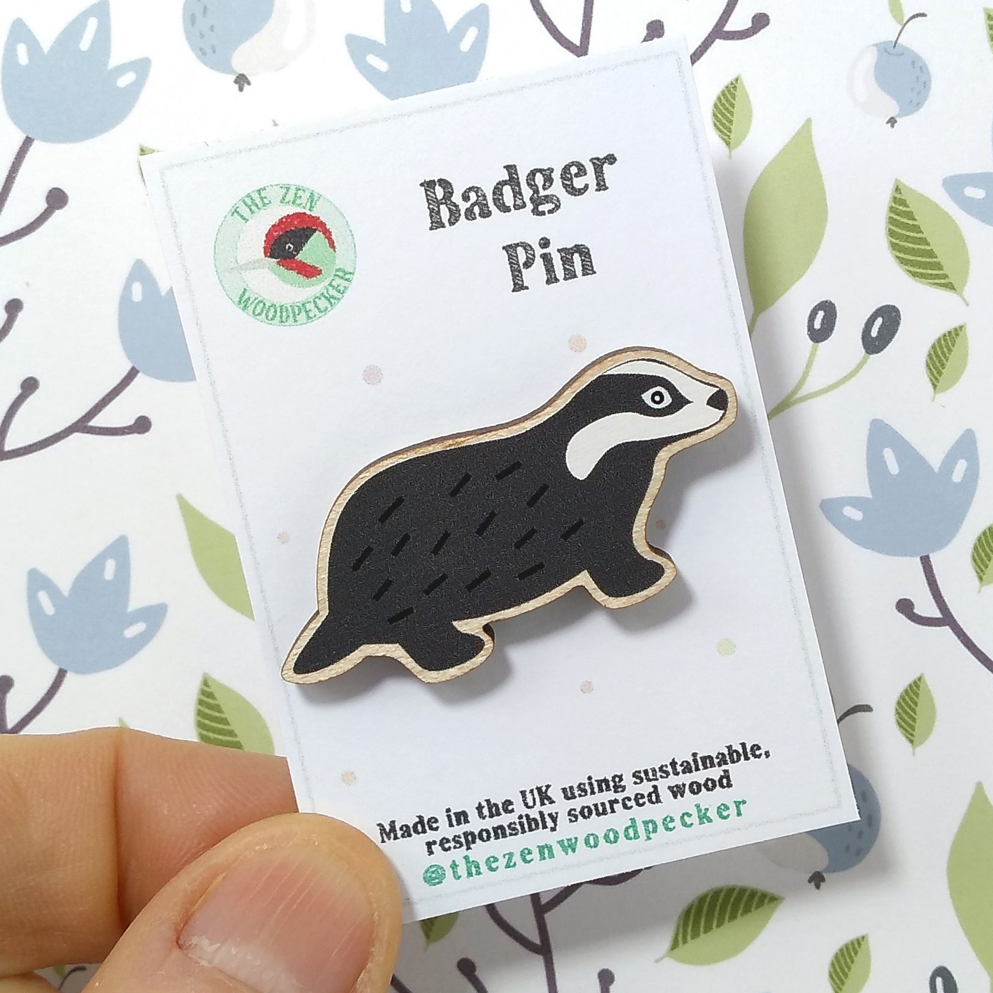 Wooden badger pin badge on display card