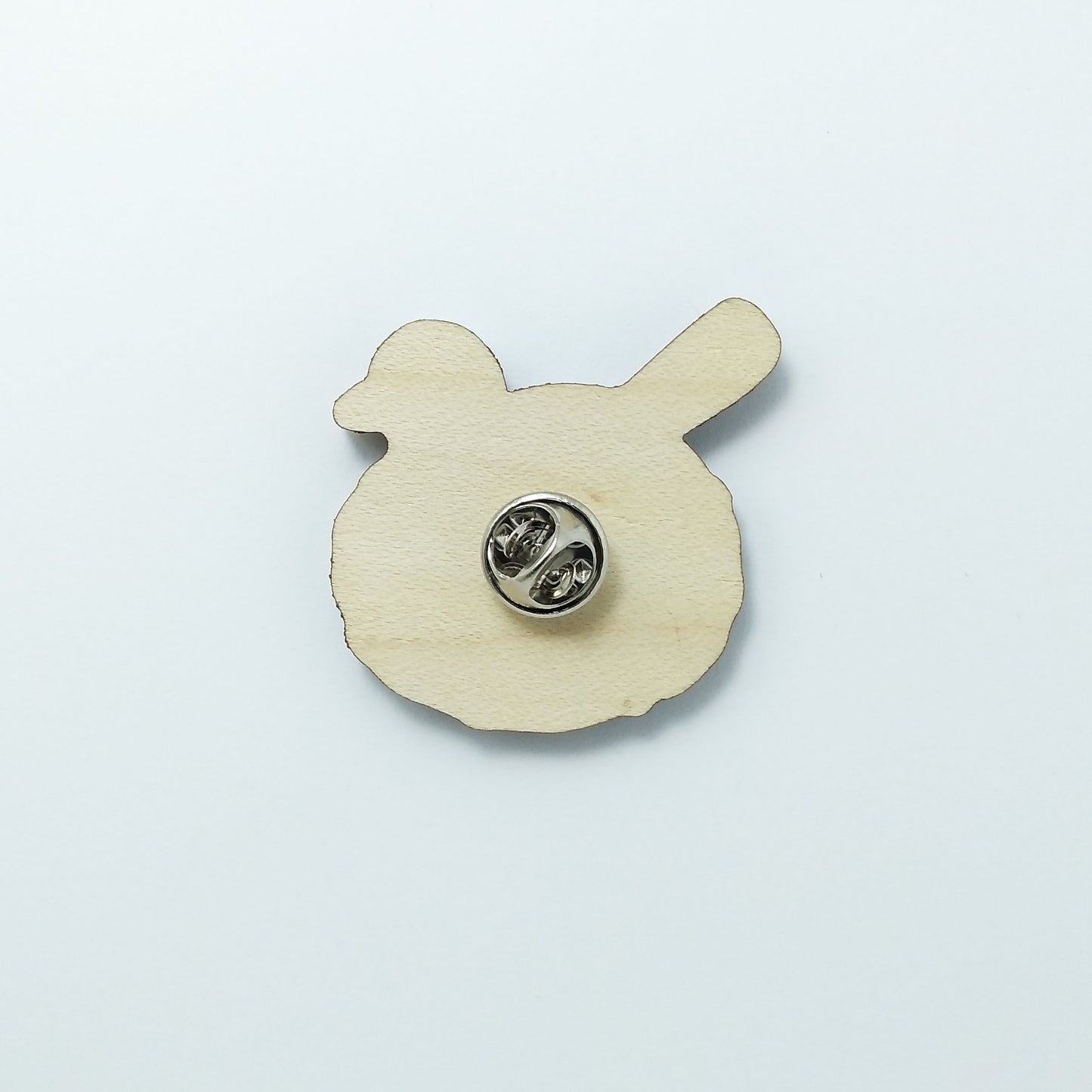 Back of blackbird pin badge showing metal butterfly clutch pin