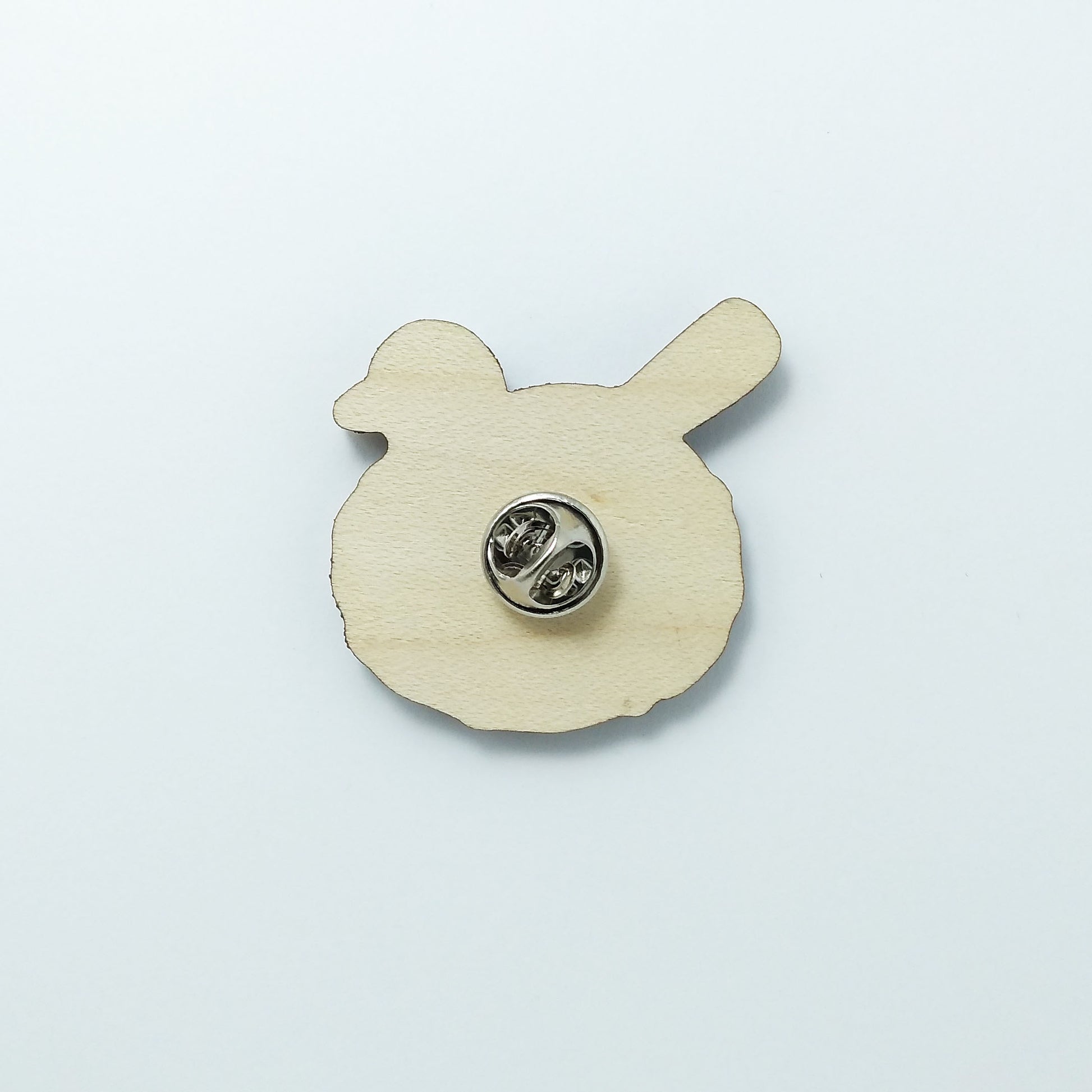 Back of blackbird pin badge showing metal butterfly clutch pin