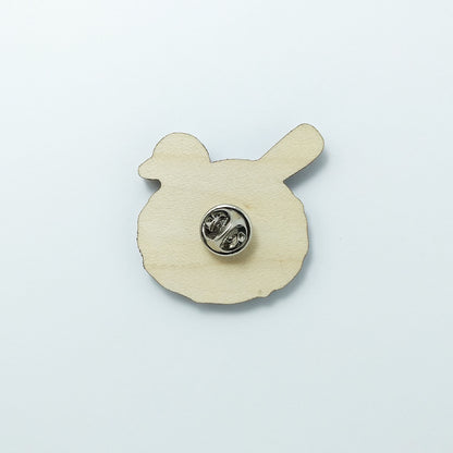 Back of blackbird pin badge showing metal butterfly clutch pin