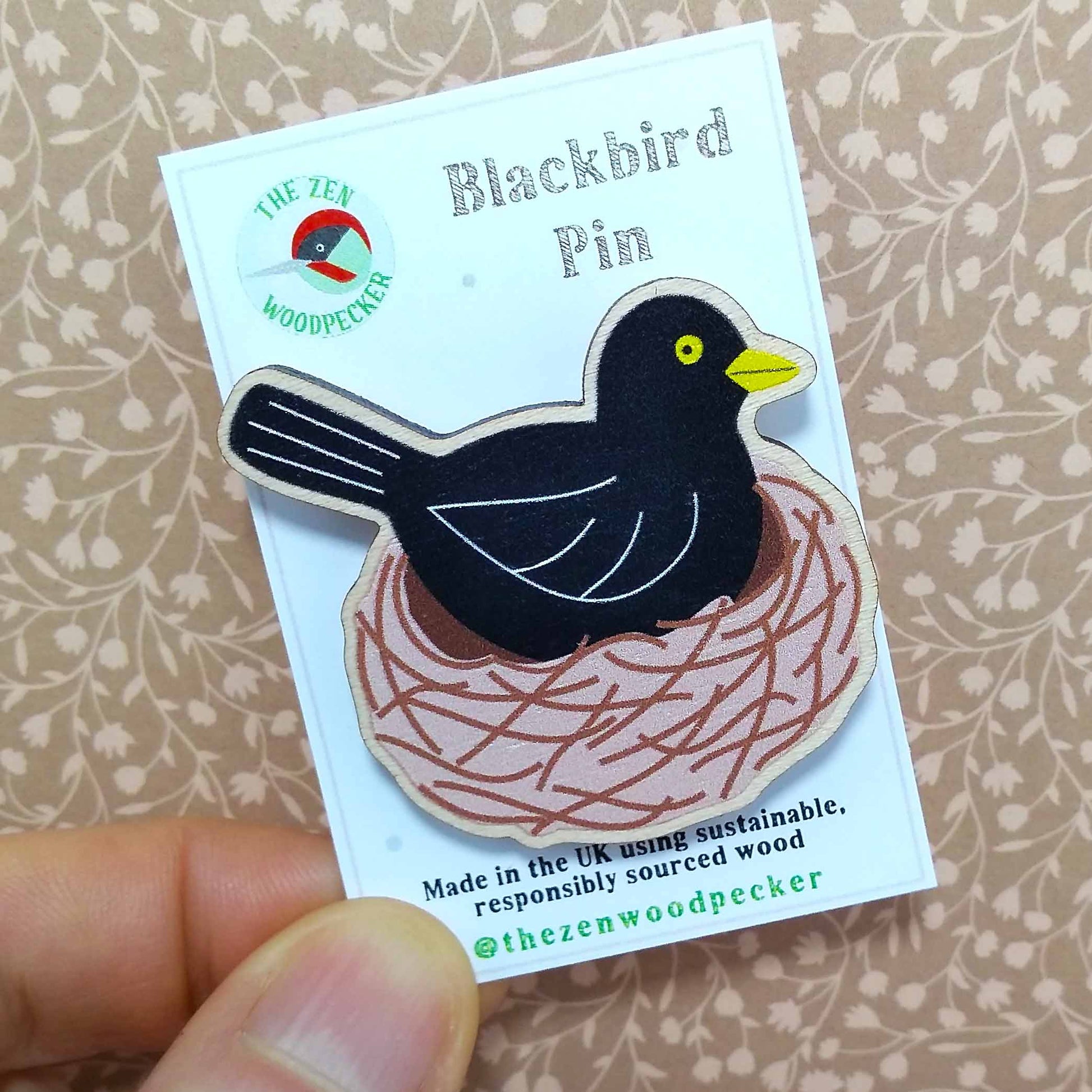 Wooden blackbird pin badge on display card