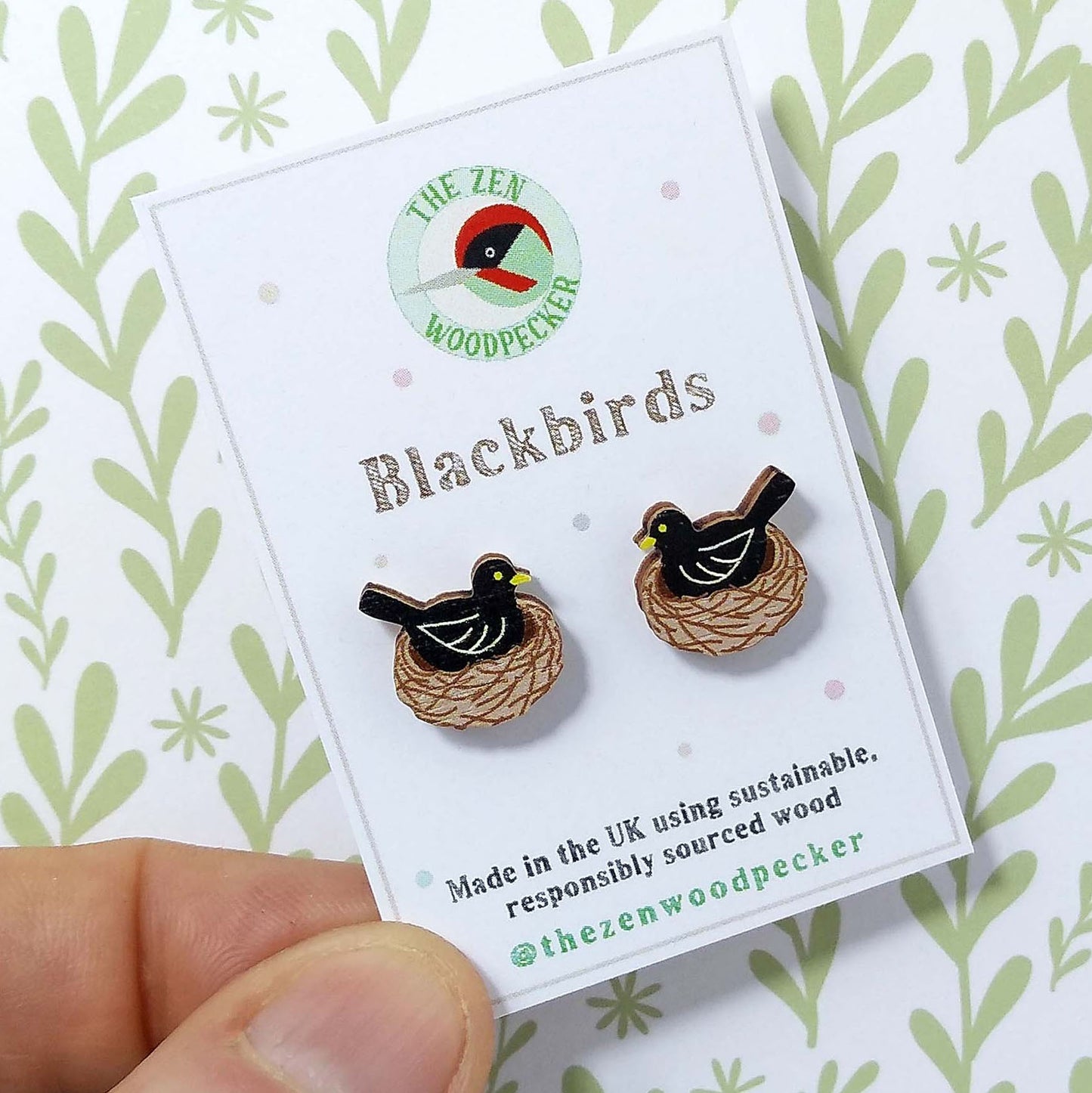 Wooden blackbird stud earrings on display card