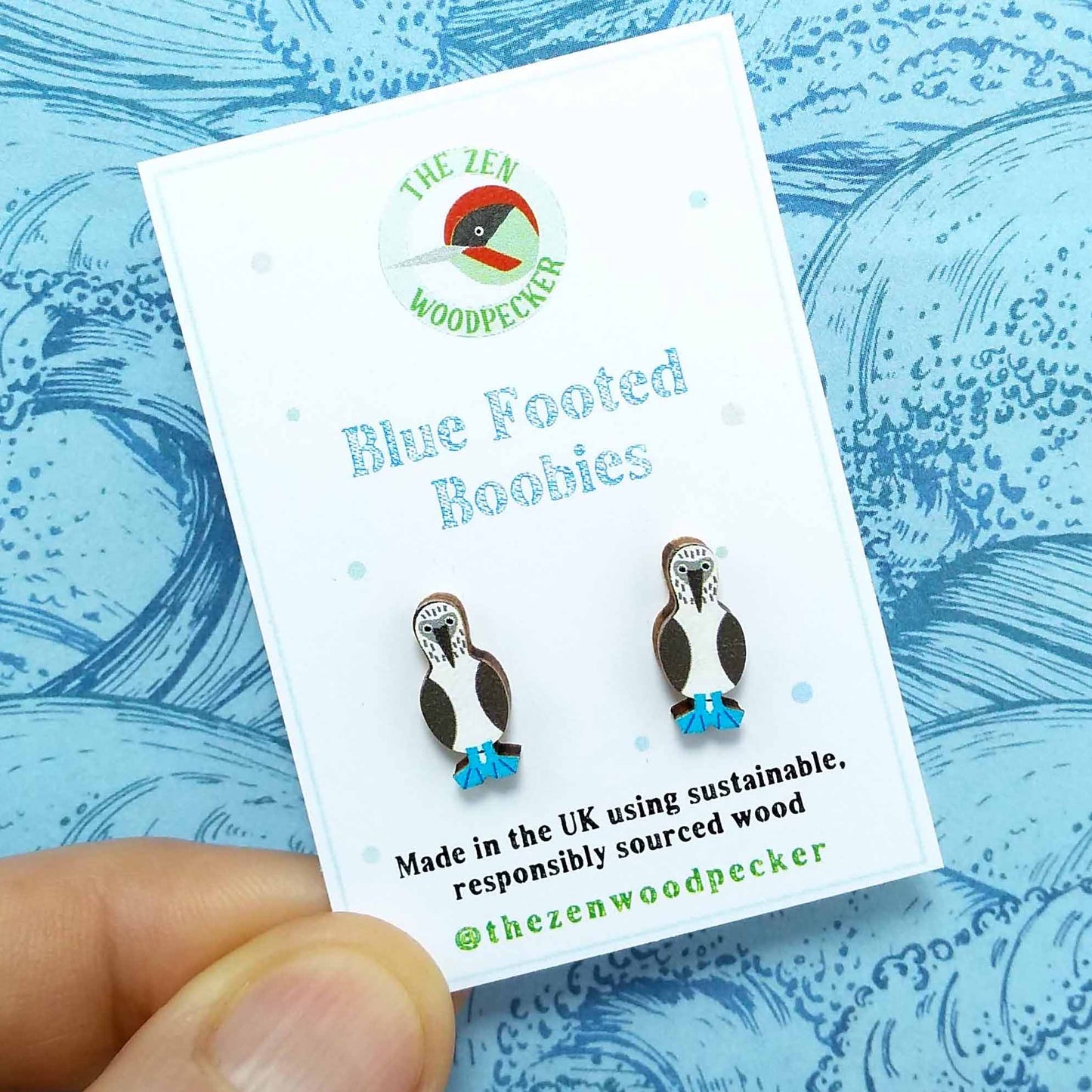 Wooden blue footed booby stud earrings on display card