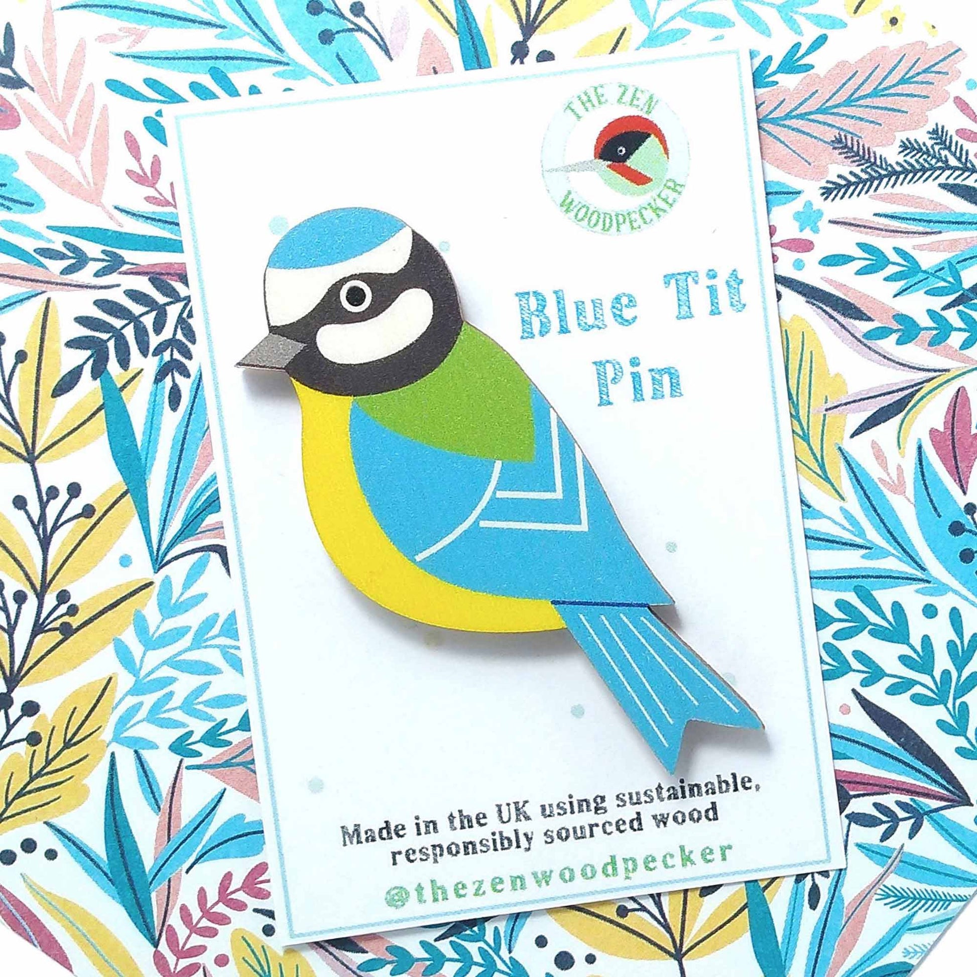 Wooden blue tit pin badge on display card
