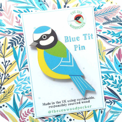 Wooden blue tit pin badge on display card