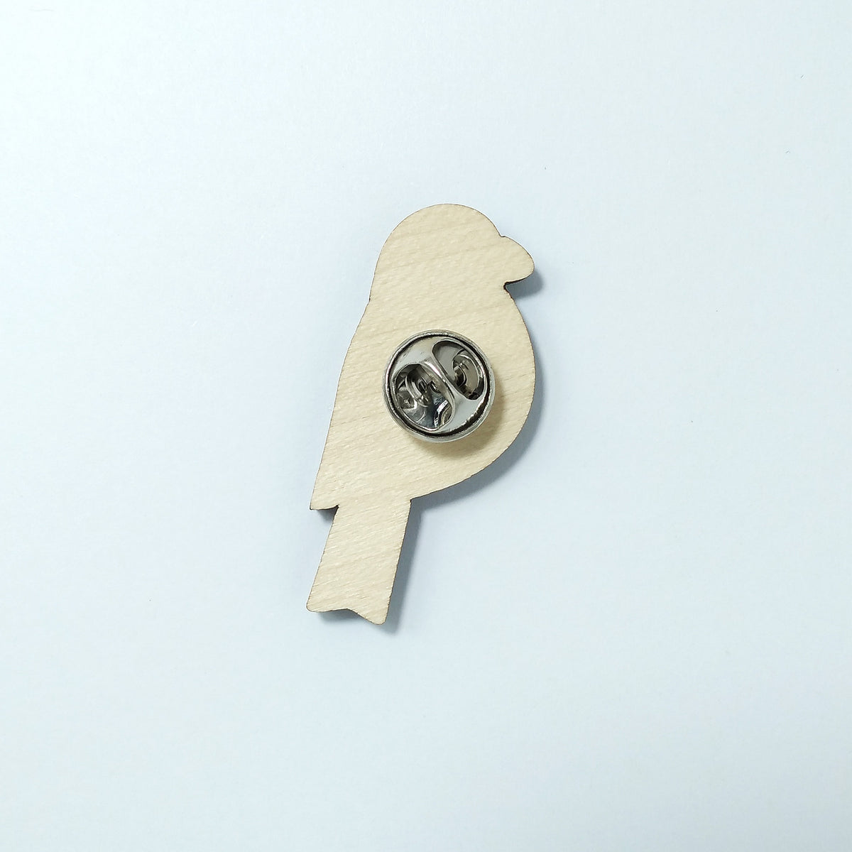 Back of bullfinch pin badge showing metal butterfly clutch pin