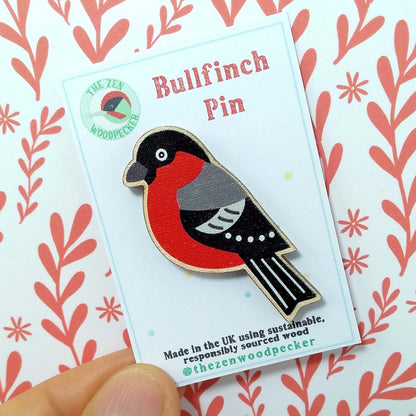 Wooden bullfinch pin badge on display card