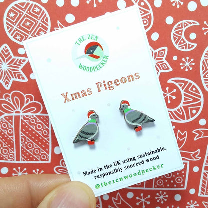 Christmas pigeon stud earrings on display card, made of wood, the pigeons are wearing red santa hats and red boots