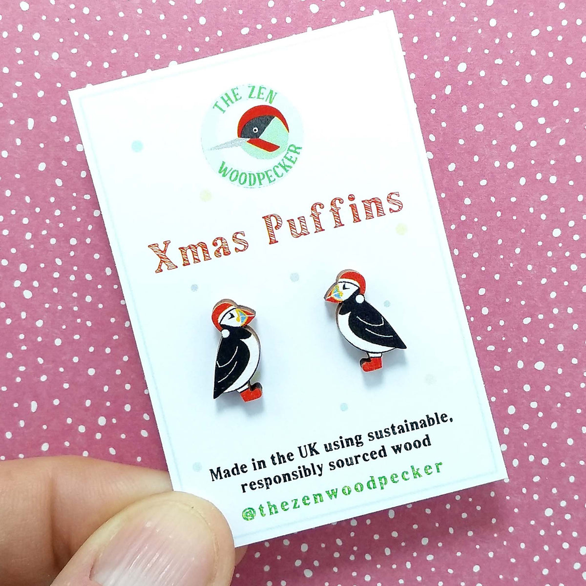 Christmas puffin stud earrings on display card, made of wood, the puffins are wearing red santa hats and red boots