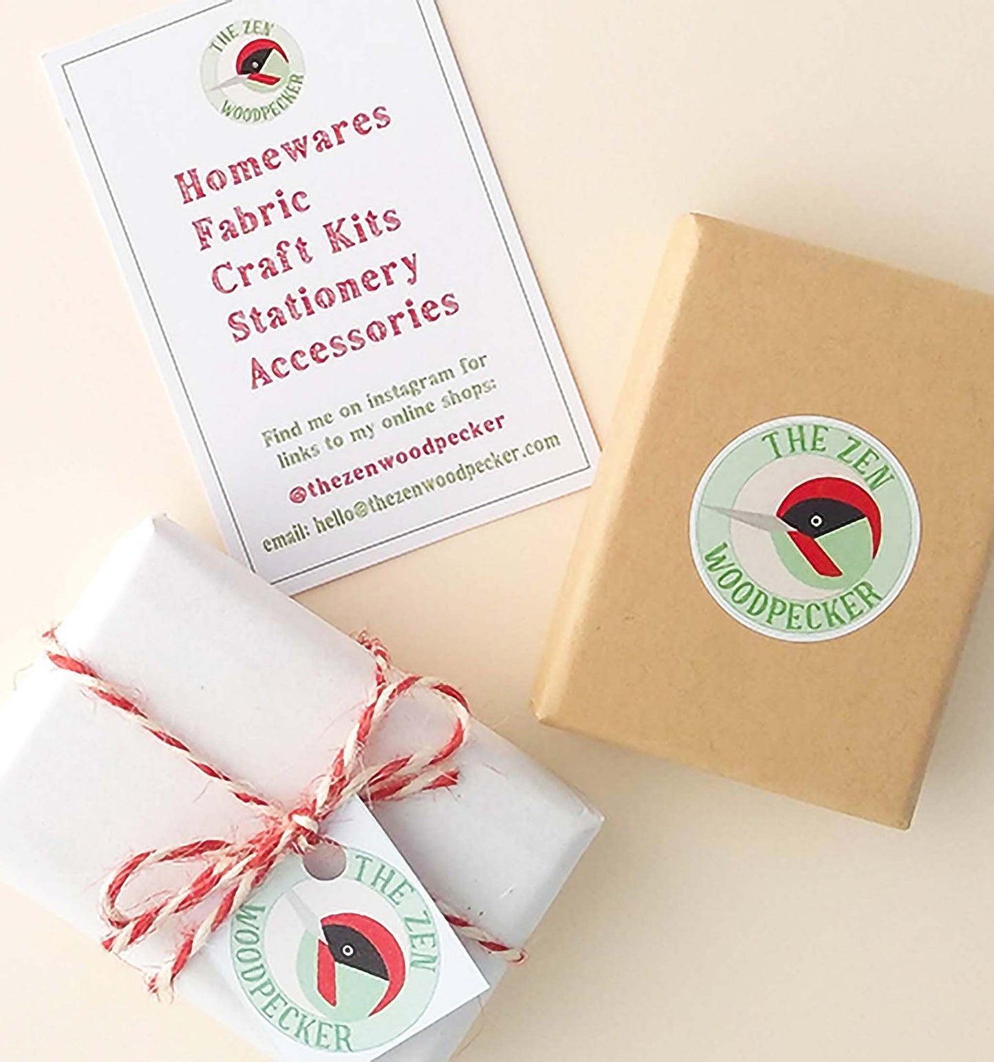 Eco friendly card gift box with logo sticker, another box gift wrapped in tissue paper and tied with string, and a business card