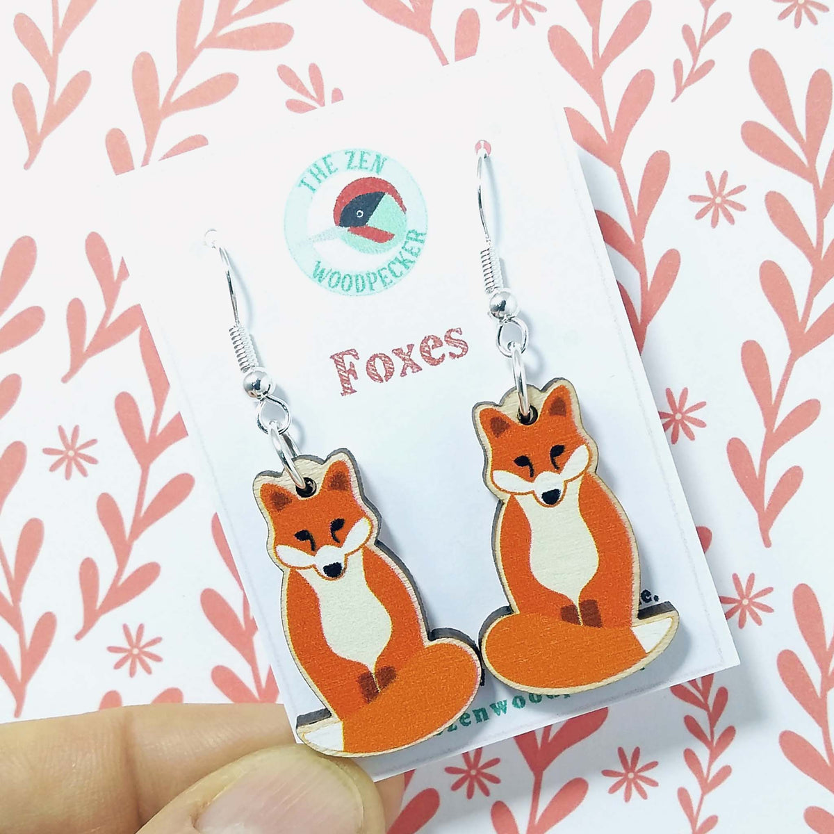 Wooden dangly fox earrings on display card