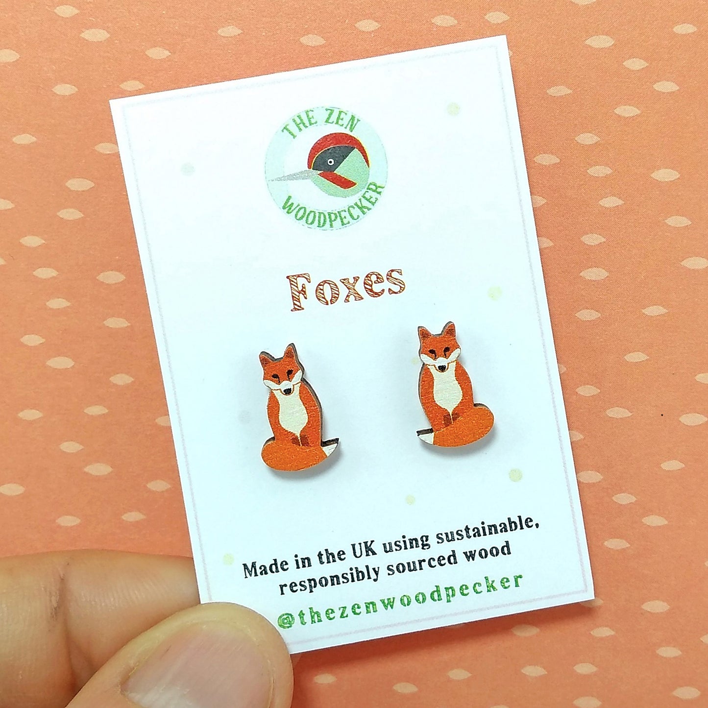 Wooden fox stud earrings on display card