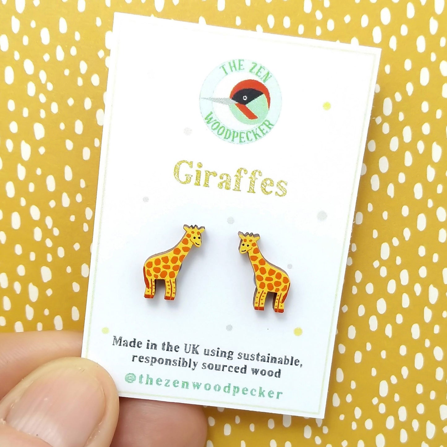 Wooden giraffe stud earrings on display card
