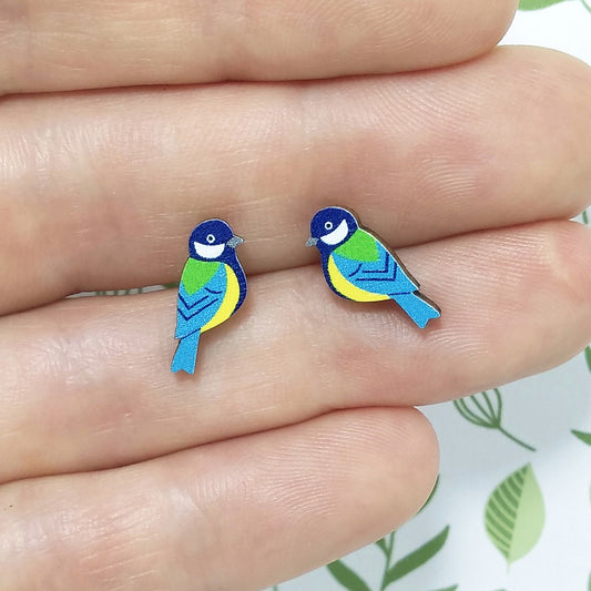 Wooden great tit stud earrings held on hand