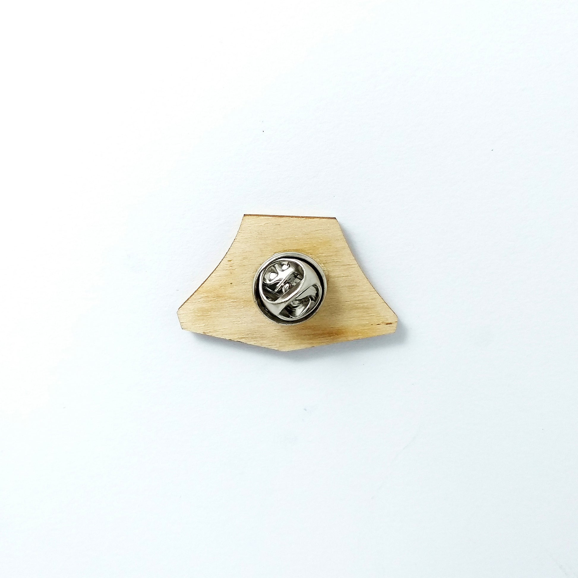 Back of green tent pin badge showing metal butterfly clutch pin