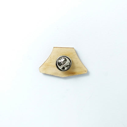 Back of green tent pin badge showing metal butterfly clutch pin