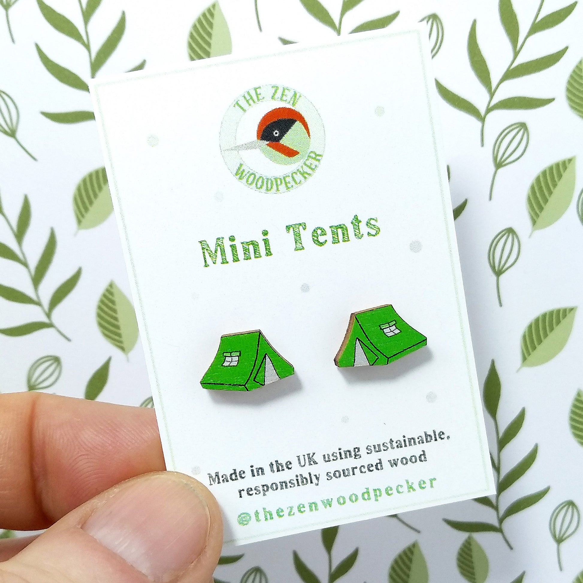 Wooden green tent stud earrings on display card