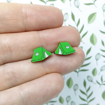 Wooden green tent stud earrings held on hand