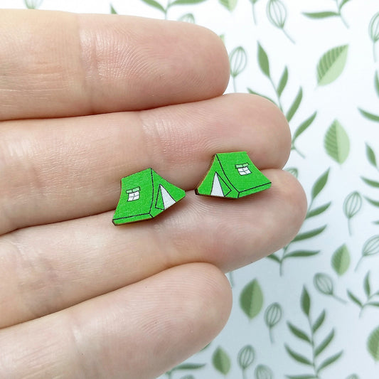 Wooden green tent stud earrings held on hand