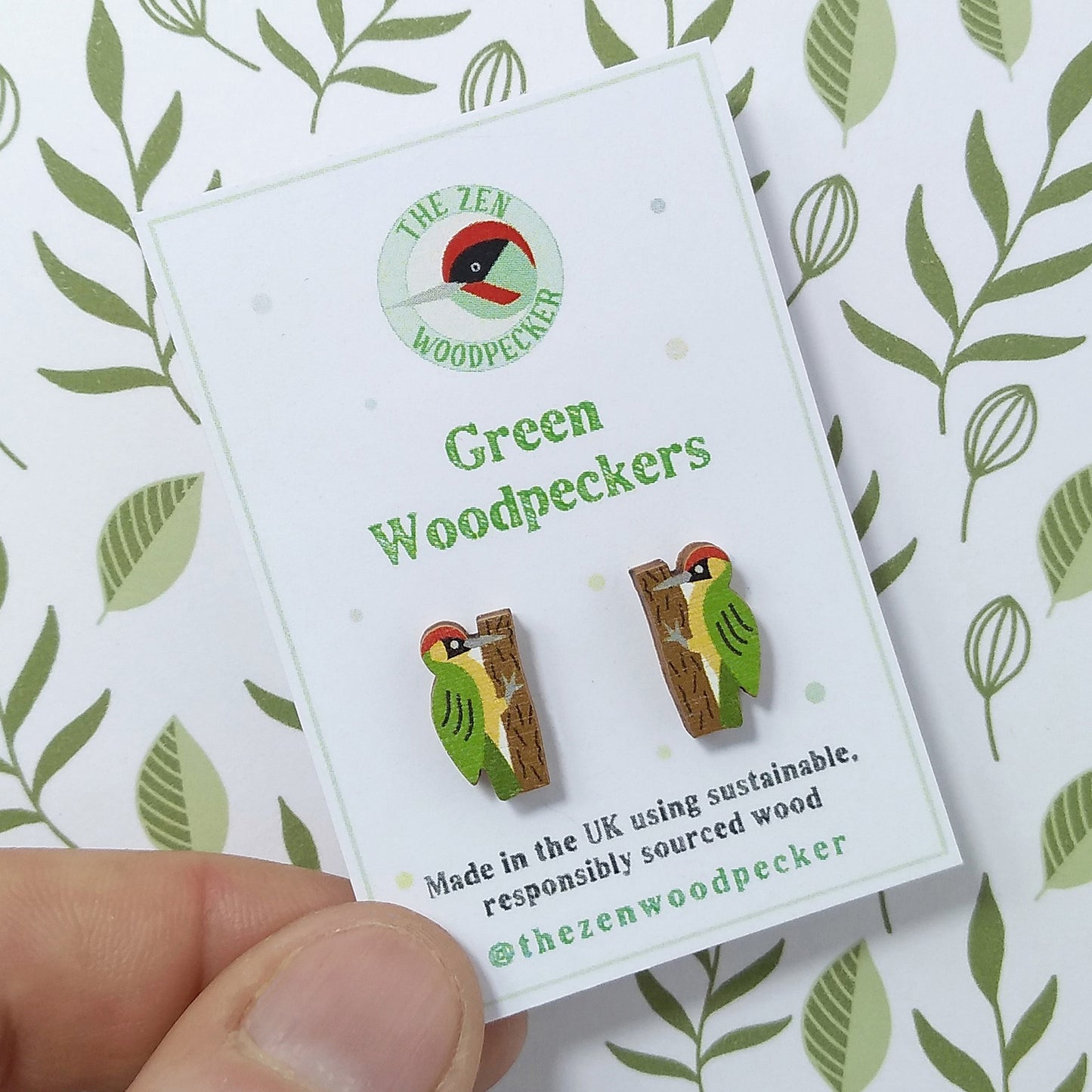 Wooden green woodpecker stud earrings on display card