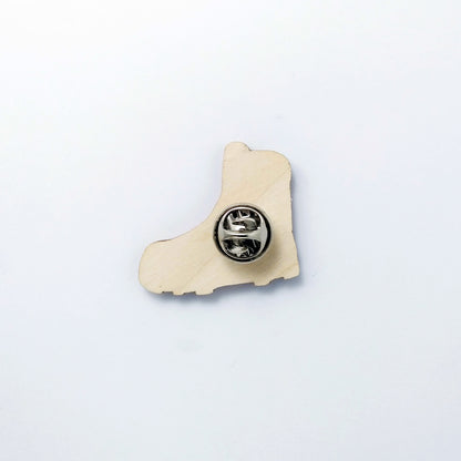 Back of hiking boot pin badge showing metal butterfly clutch pin
