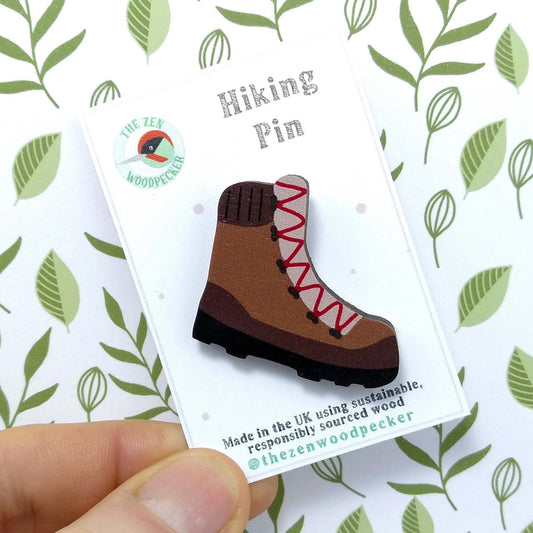 Wooden hiking boot pin badge on display card