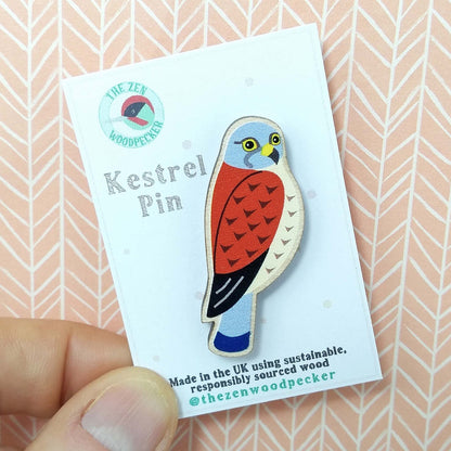 Wooden kestrel pin badge on display card