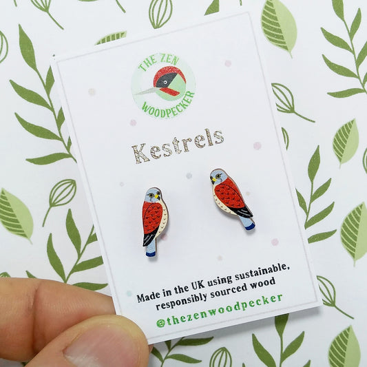 Wooden kestrel stud earrings on display card