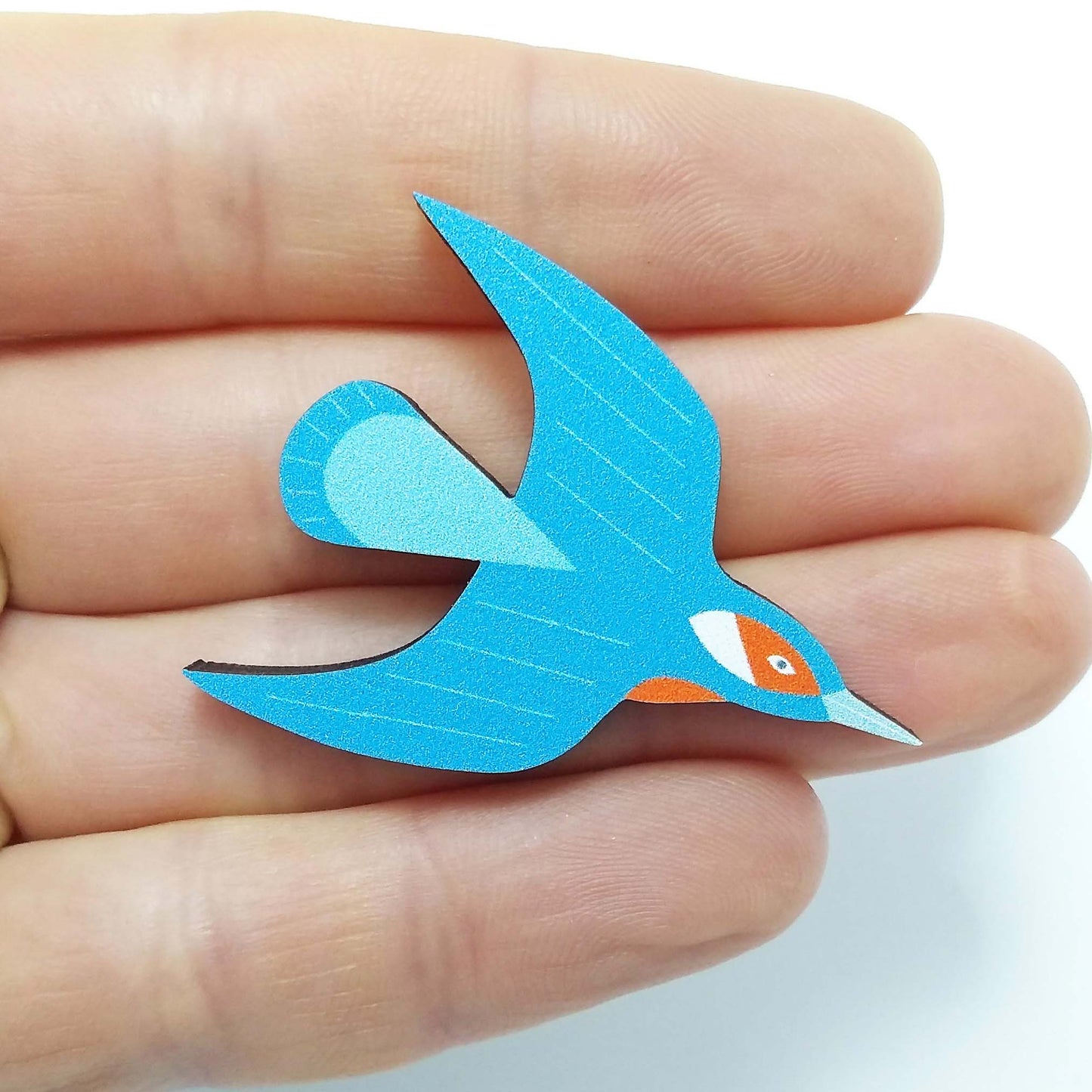 Wooden kingfisher pin badge held on hand