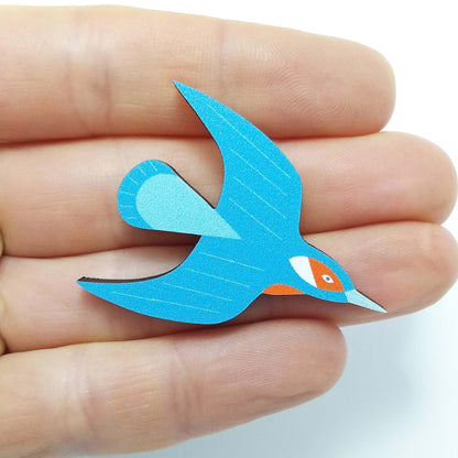 Wooden kingfisher pin badge held on hand