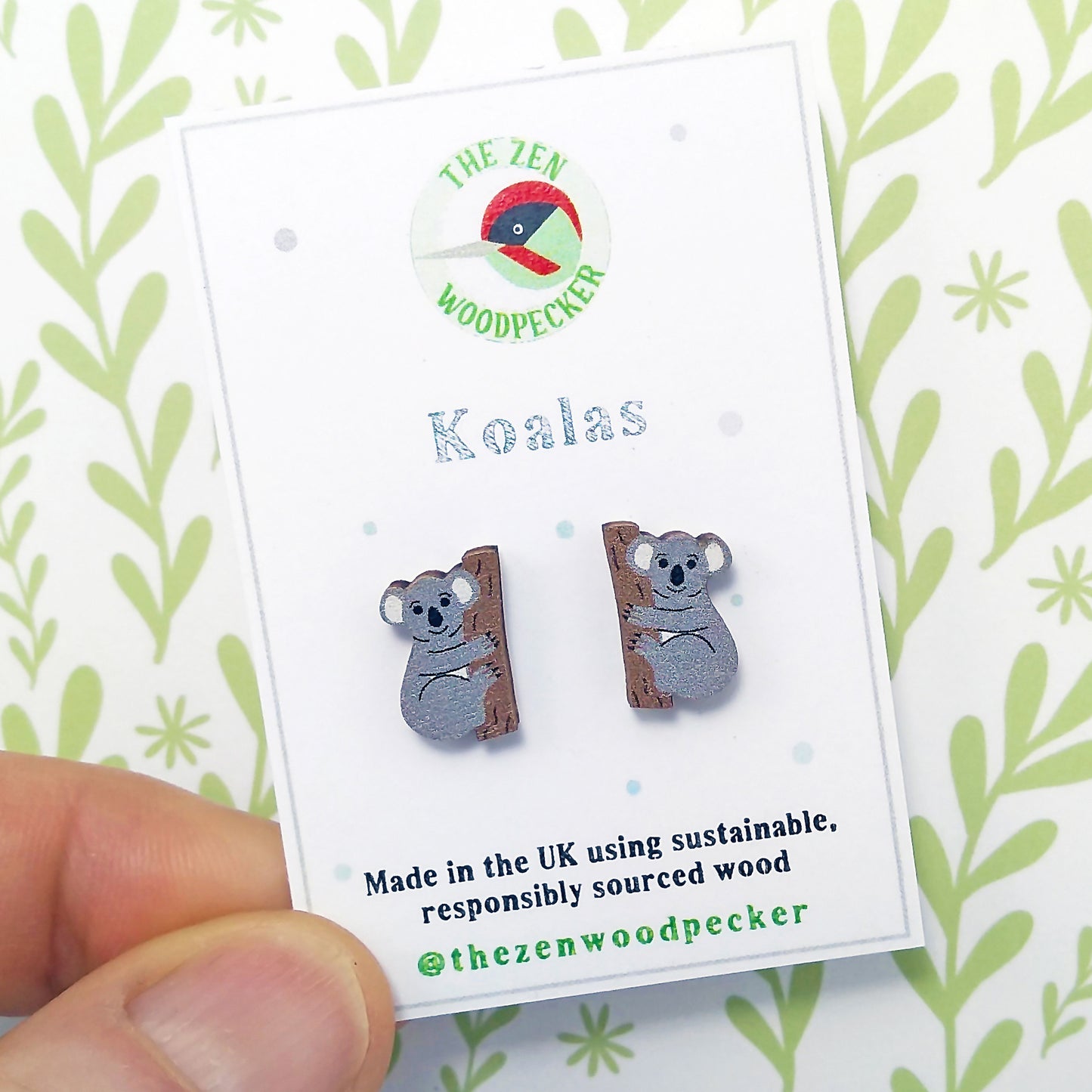 Wooden koala stud earrings on display card