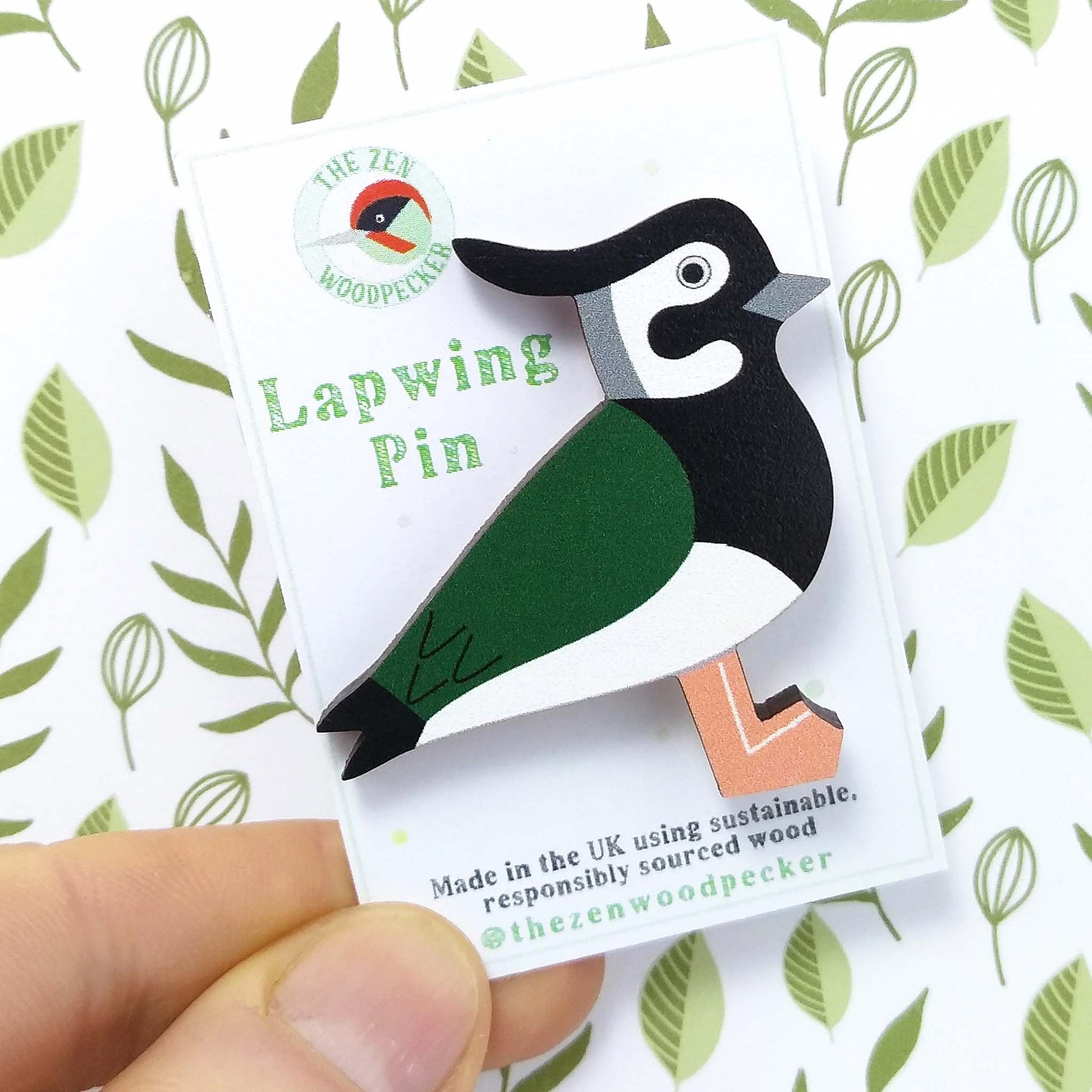 Wooden lapwing pin badge on display card