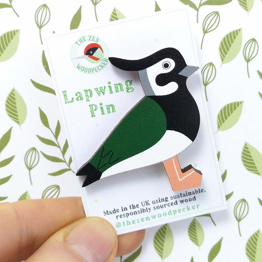 Wooden lapwing pin badge on display card