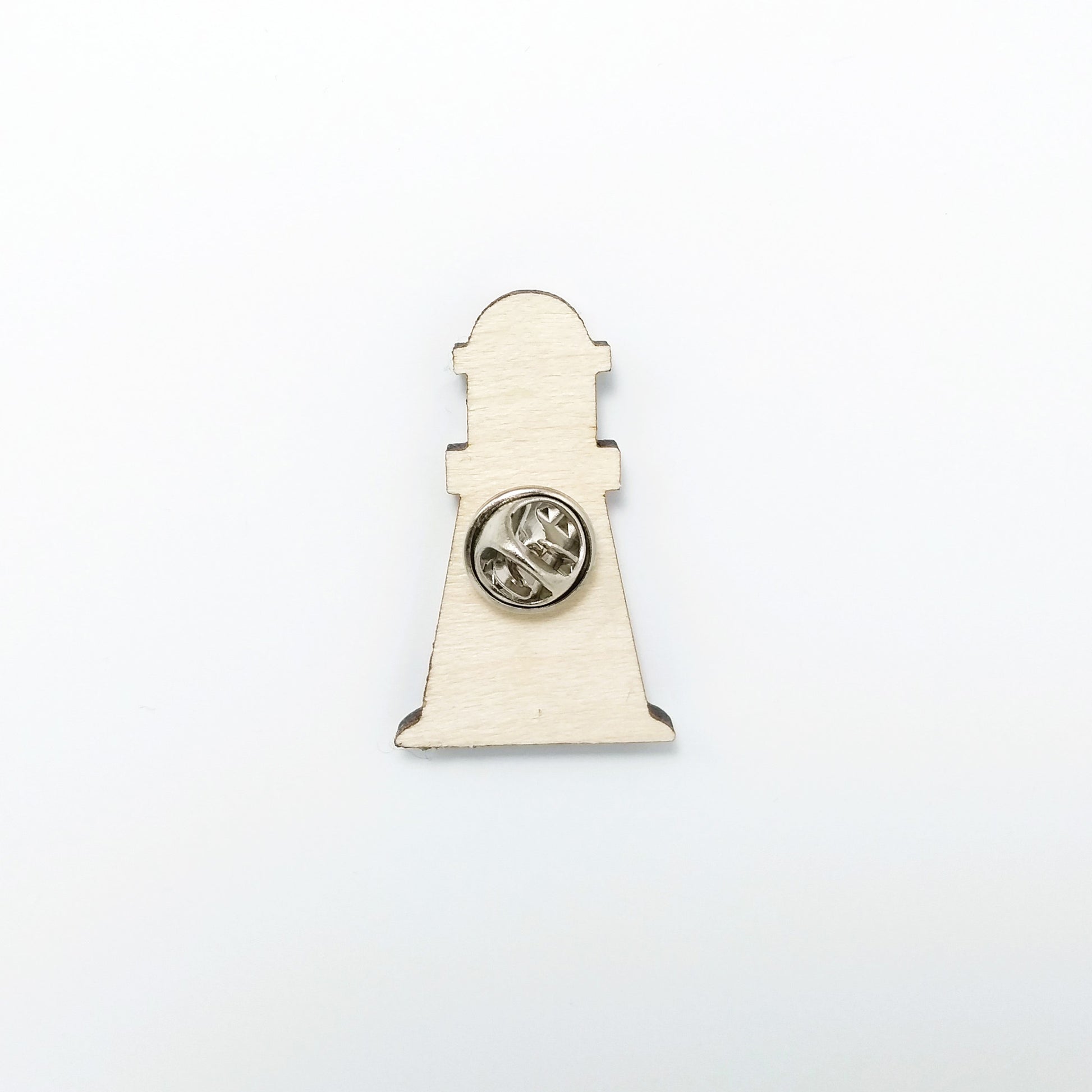 Back of lighthouse pin badge showing metal butterfly clutch pin