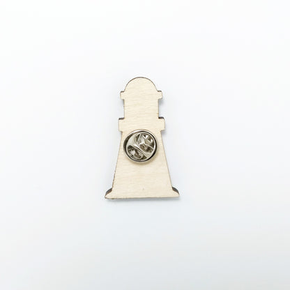 Back of lighthouse pin badge showing metal butterfly clutch pin