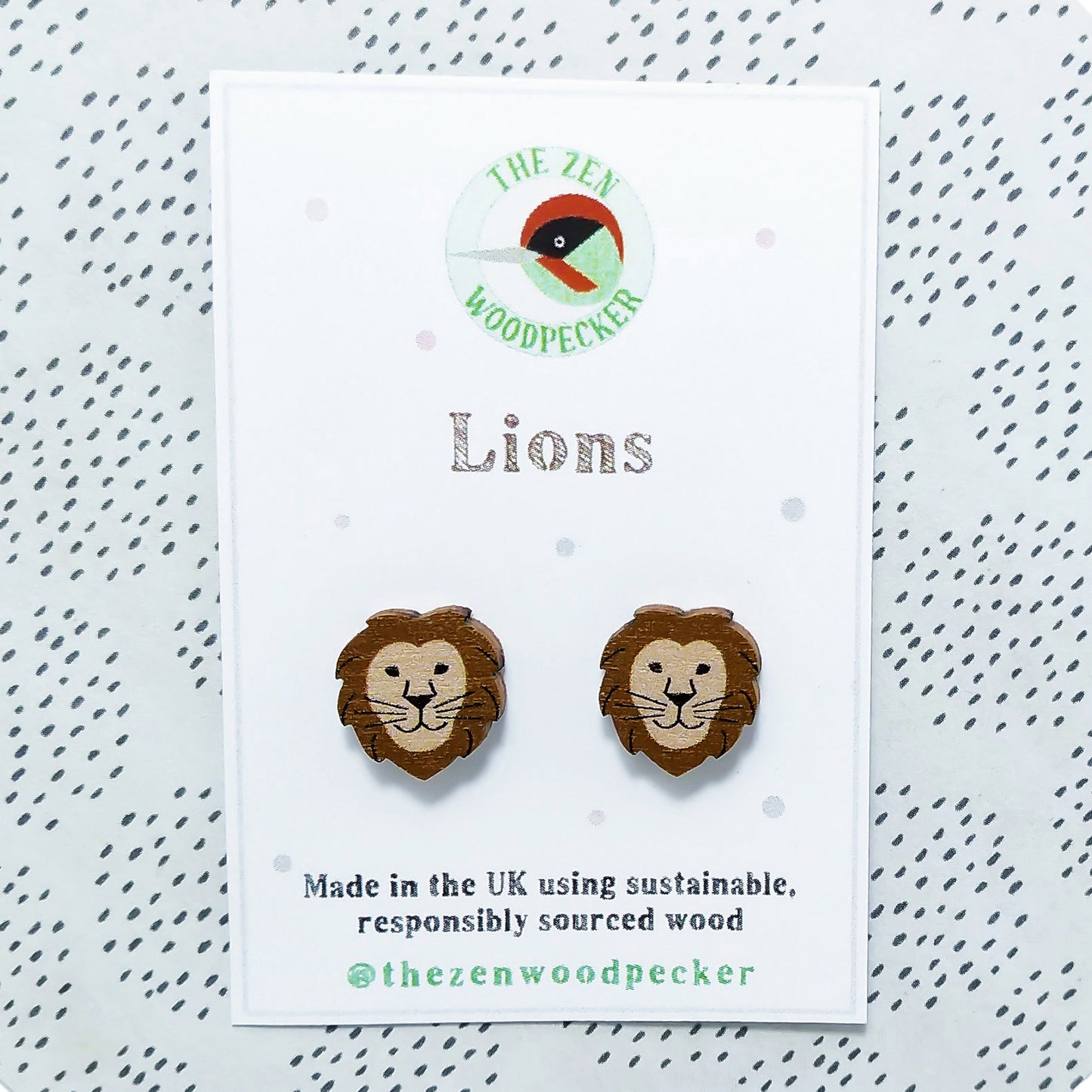 Wooden lion stud earrings on display card