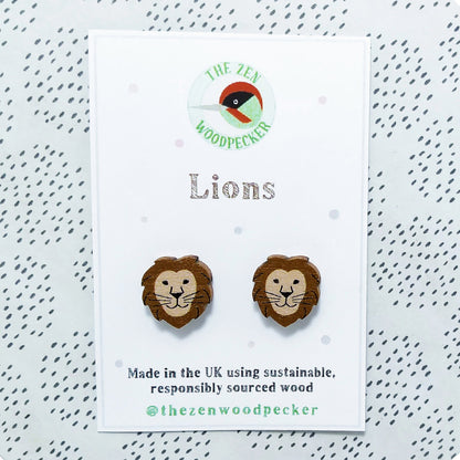 Wooden lion stud earrings on display card
