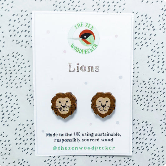 Wooden lion stud earrings on display card