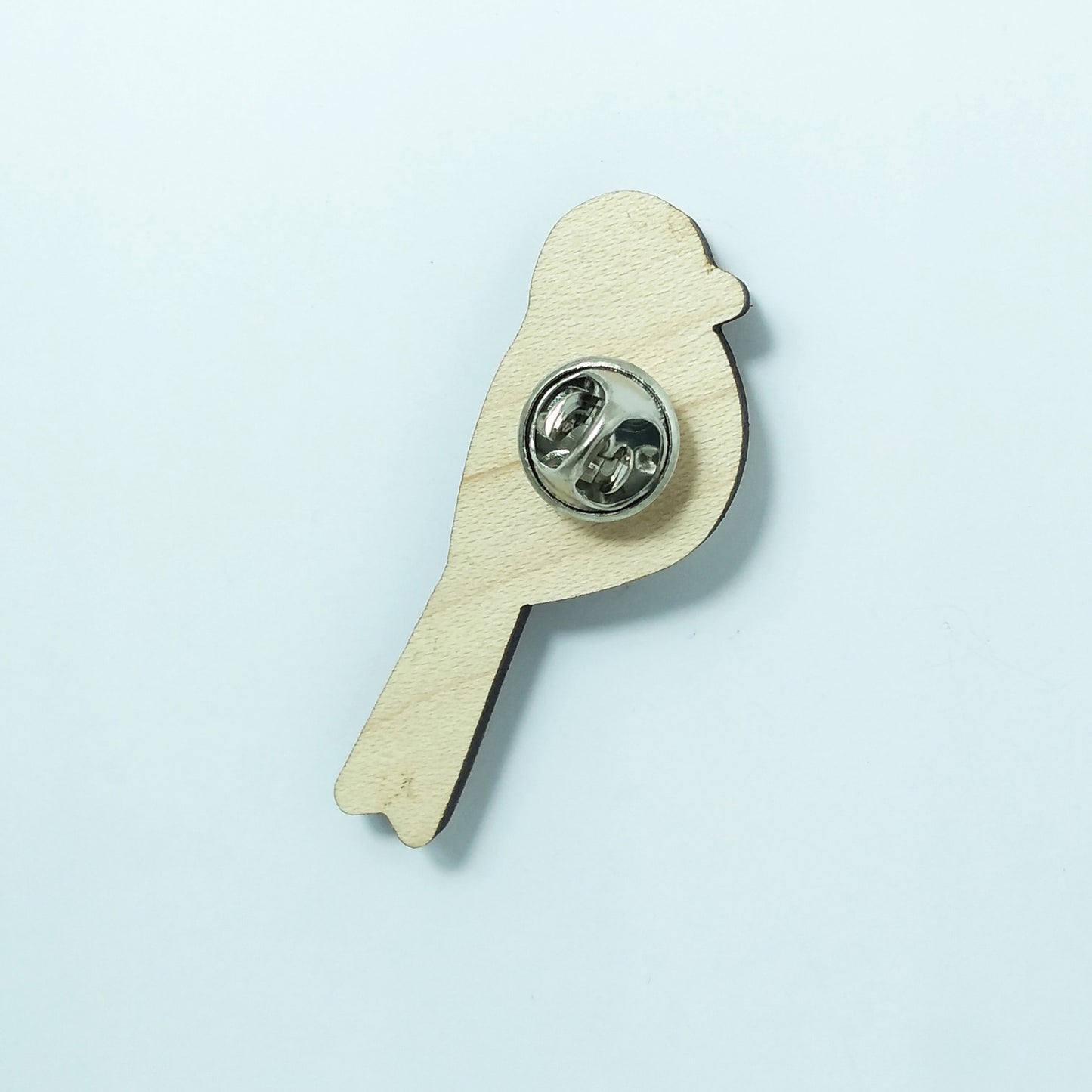 Back of long tailed tit pin badge showing metal butterfly clutch pin