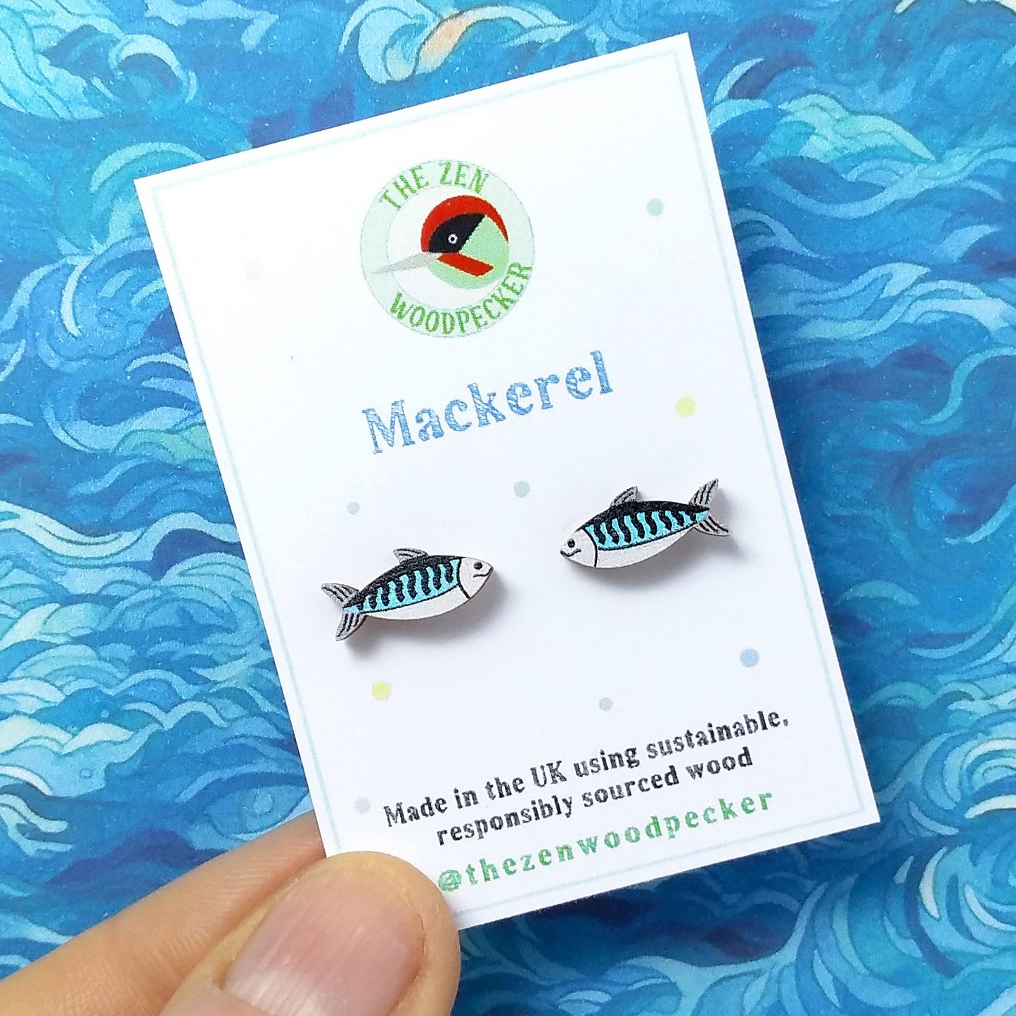Wooden mackerel stud earrings on display card