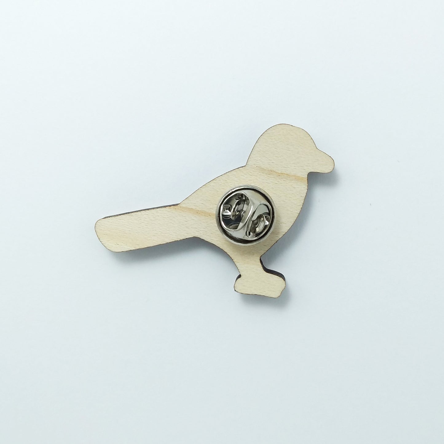 Back of magpie pin badge showing metal butterfly clutch pin