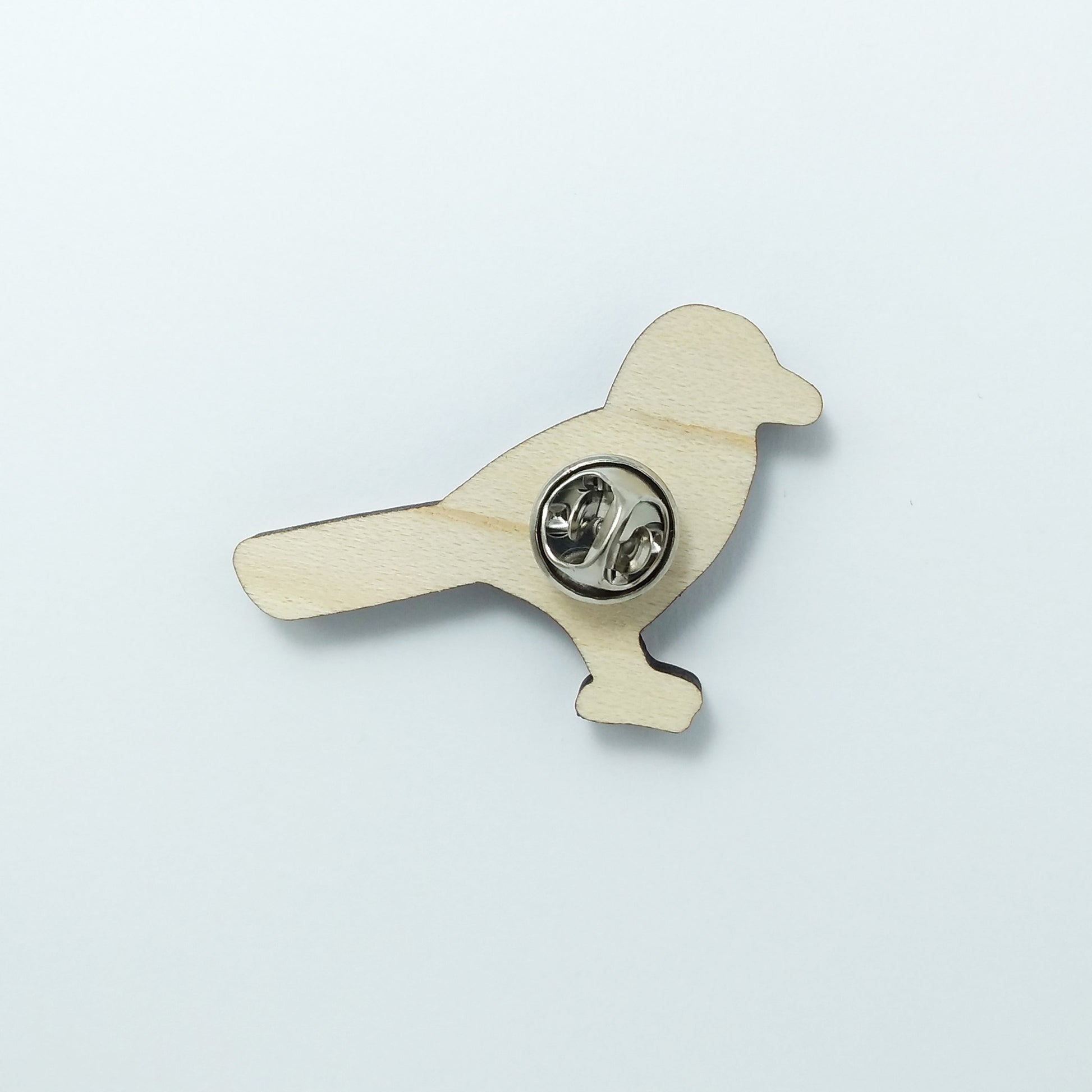 Back of magpie pin badge showing metal butterfly clutch pin